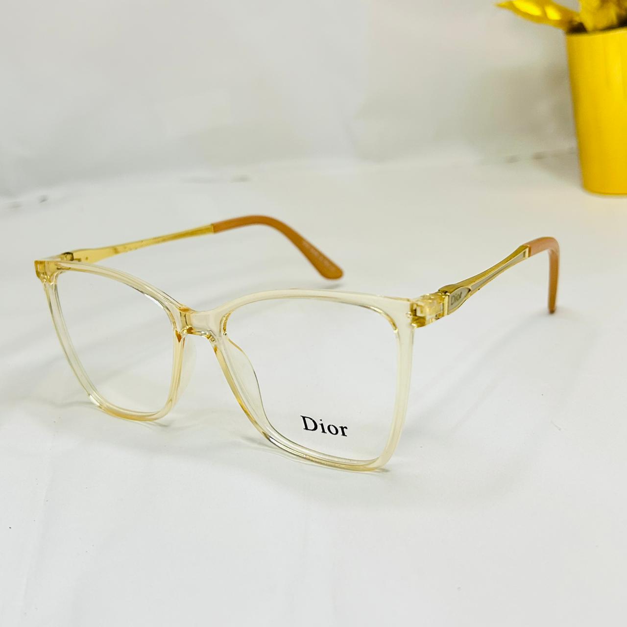 Gold-framed glasses with 'Dior' logo
